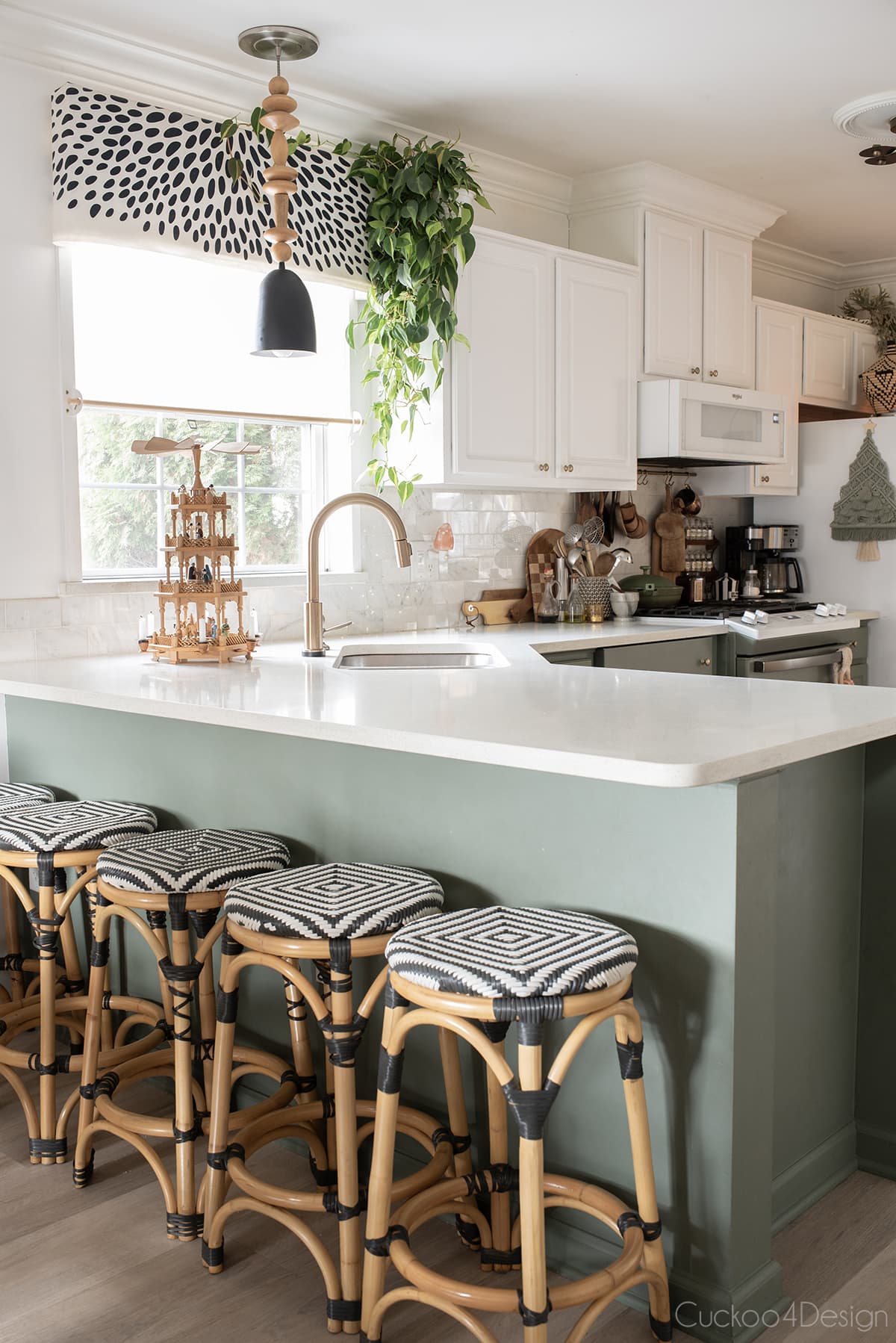 kitchen with green cabinets, quartz countertops, and Christmas decor