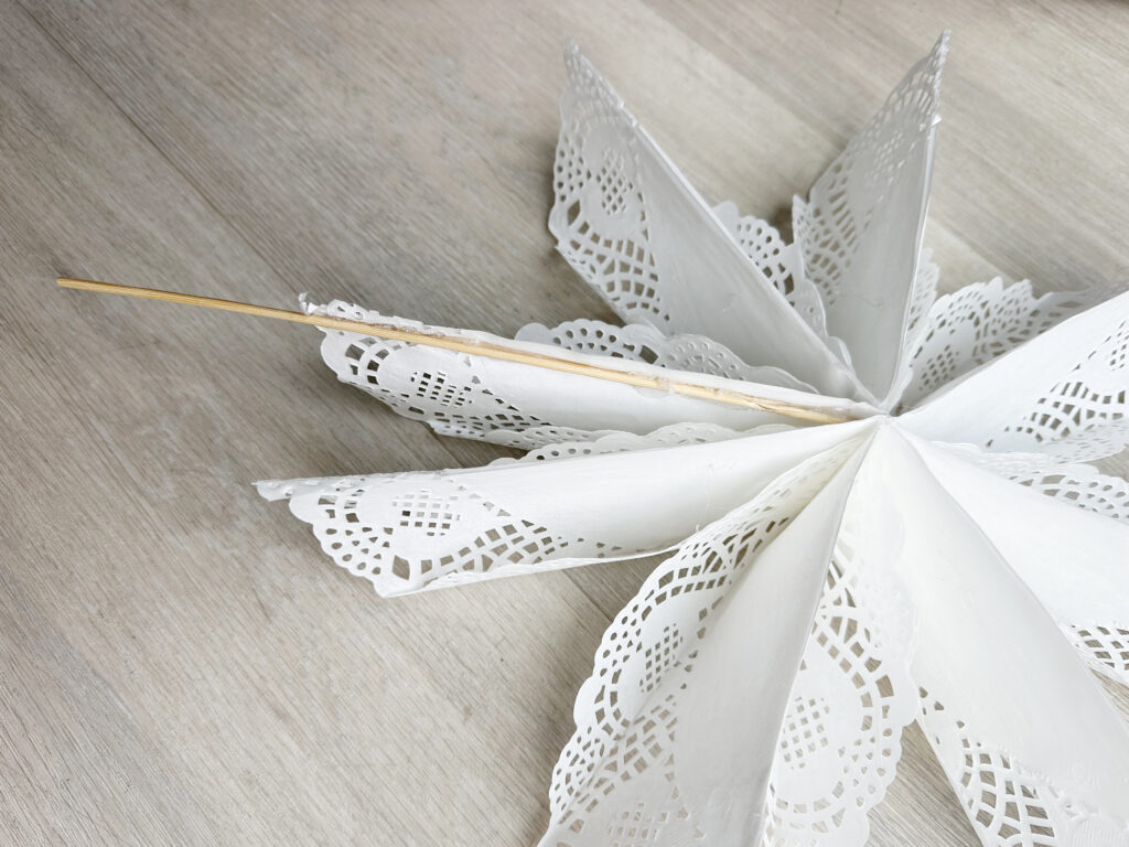 skewer glued to the back of a flat doily snowflake