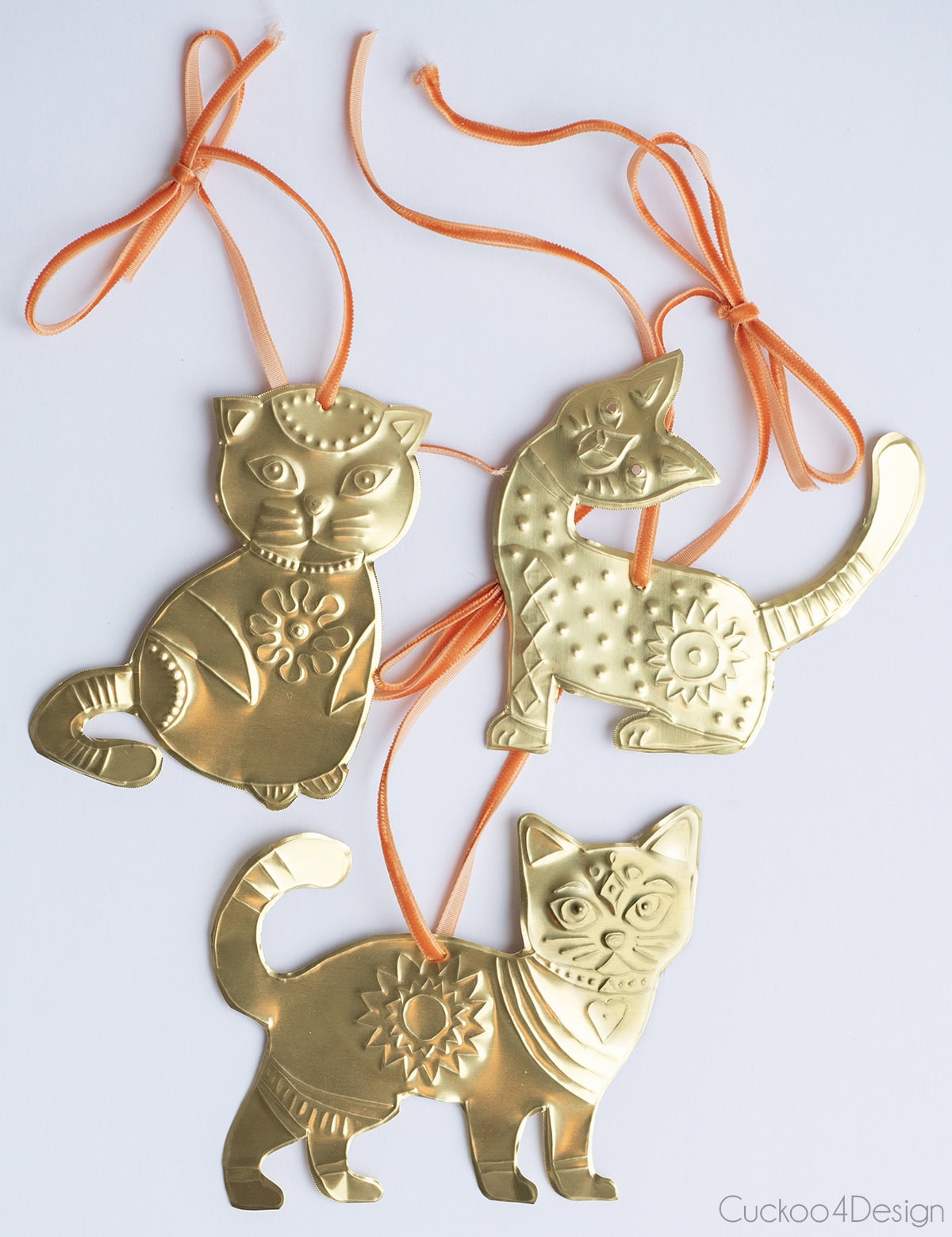 three different embossed brass DIY cat ornaments