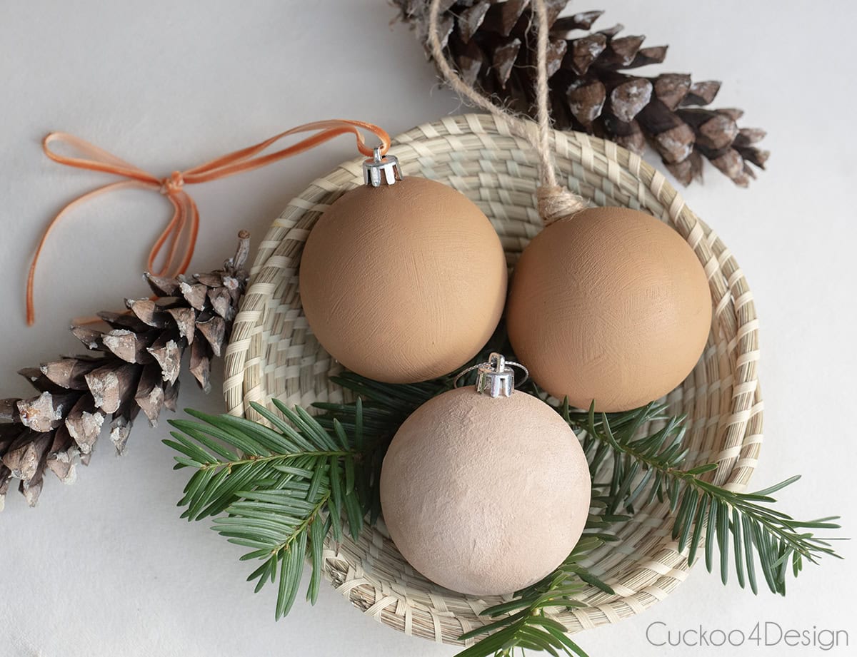 three different colored DIY baking soda paint ornaments with a velvet texture