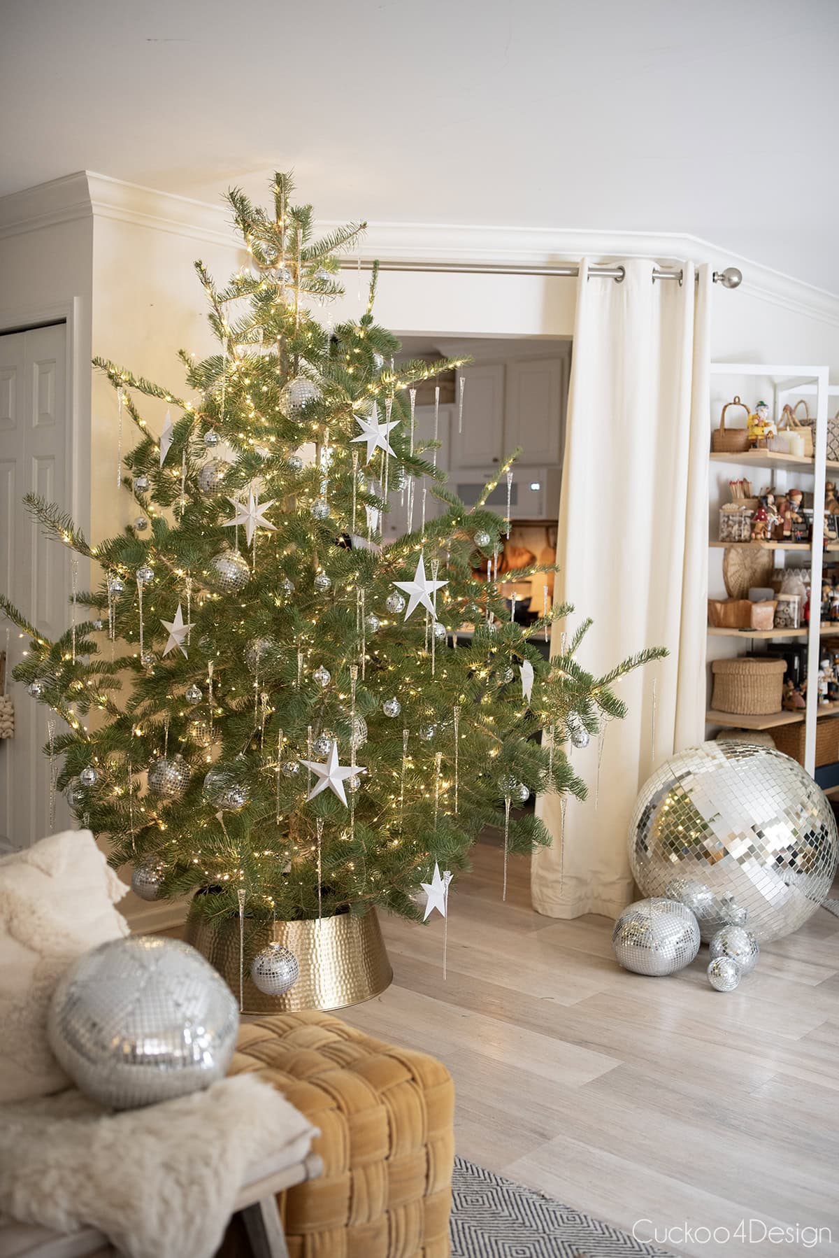front view Christmas tree with disco balls and folded paper stars on