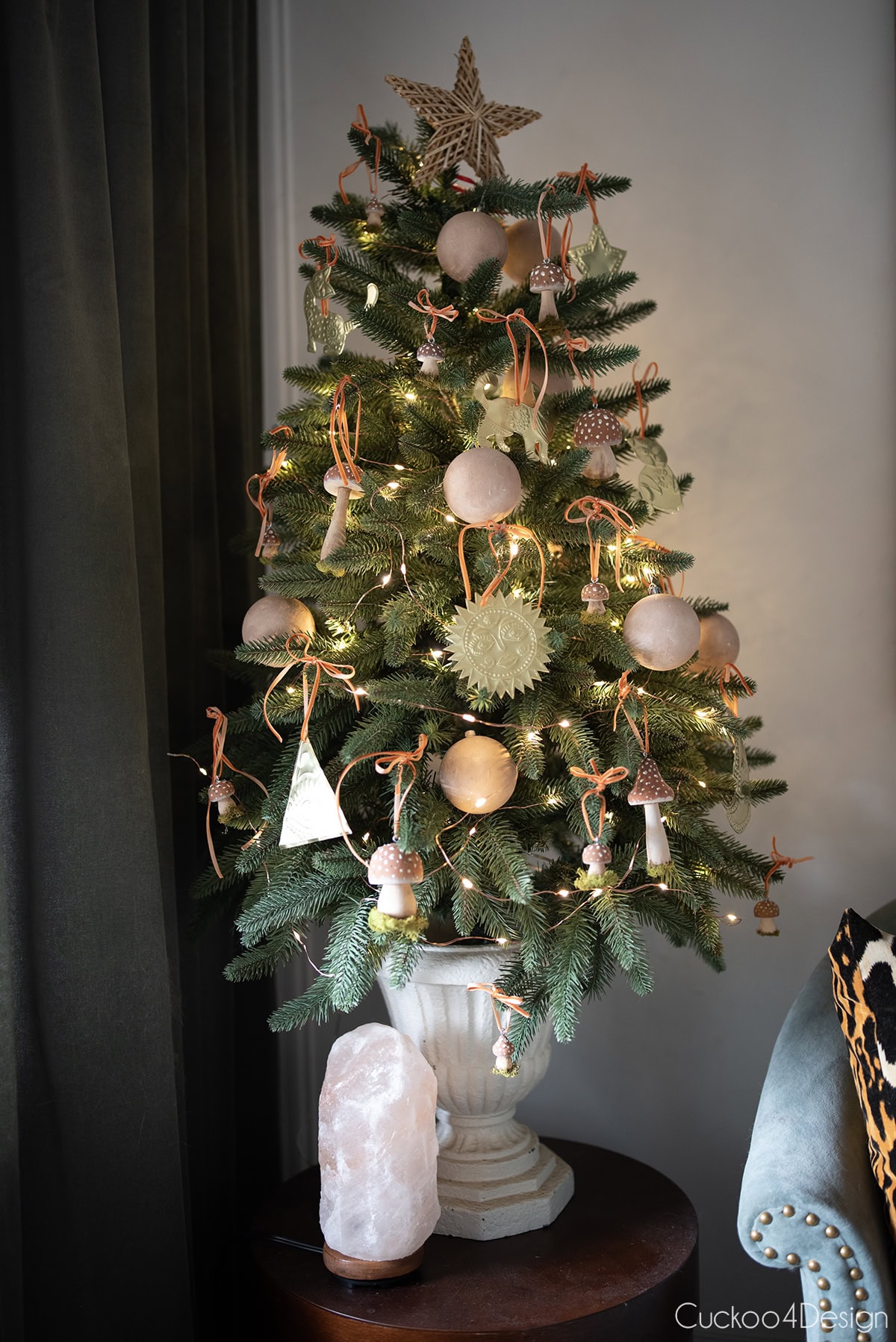 close-up of small Christmas tree with tin ornaments and mushroom ornaments