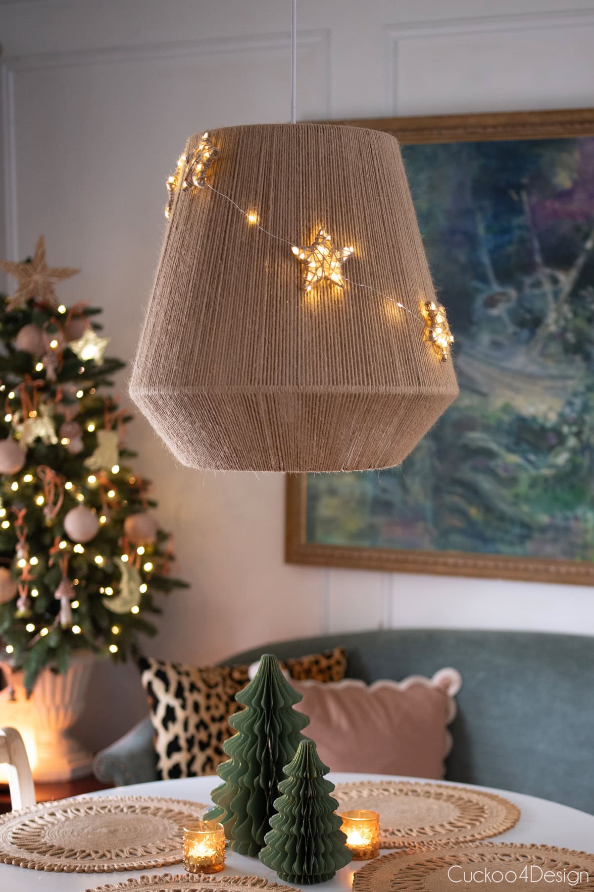 DIY light-up yarn star ornaments hanging on dining room pendant light