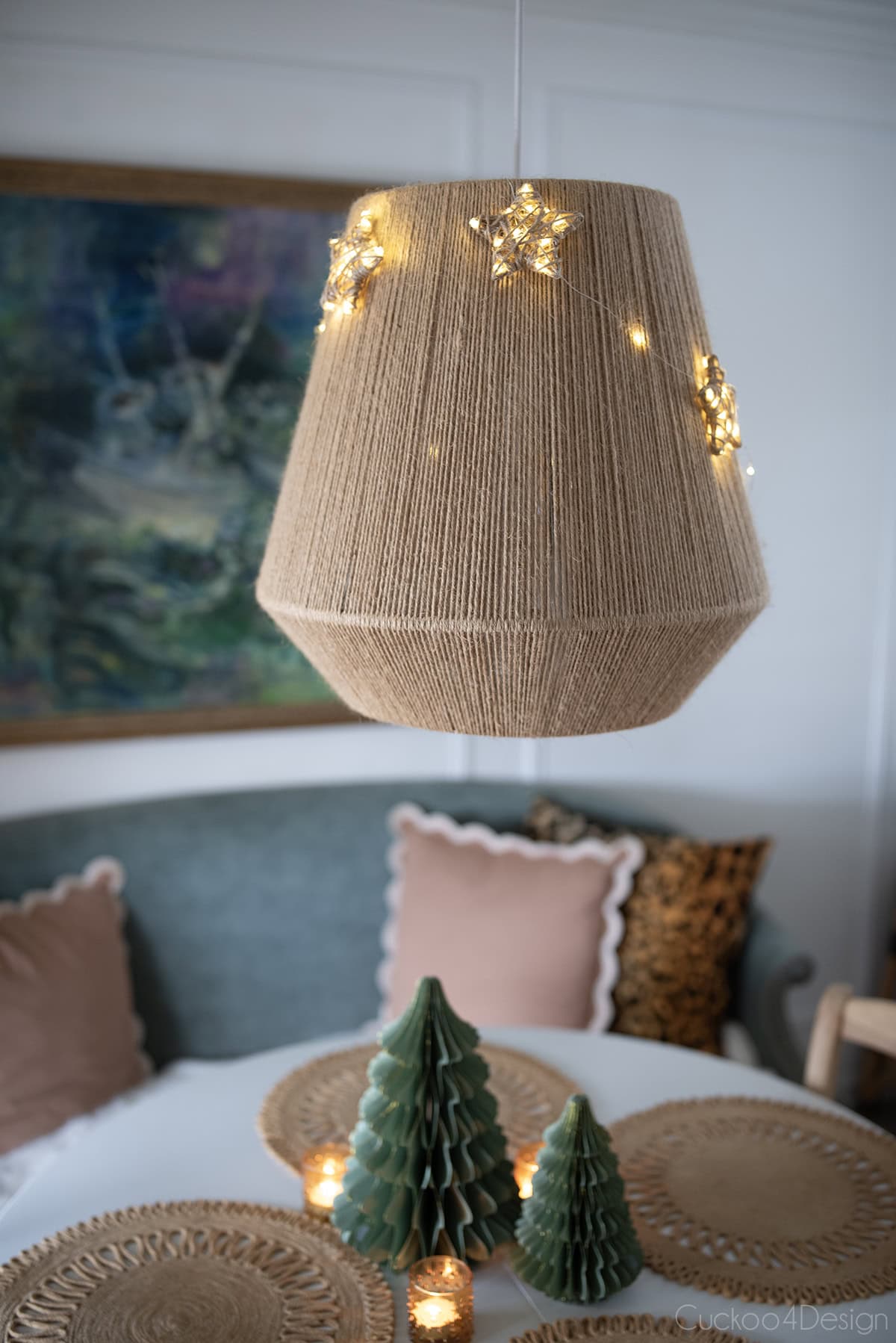 close-up of dining room pendant light made from jute yarn with fairy light jute yarn star ornaments