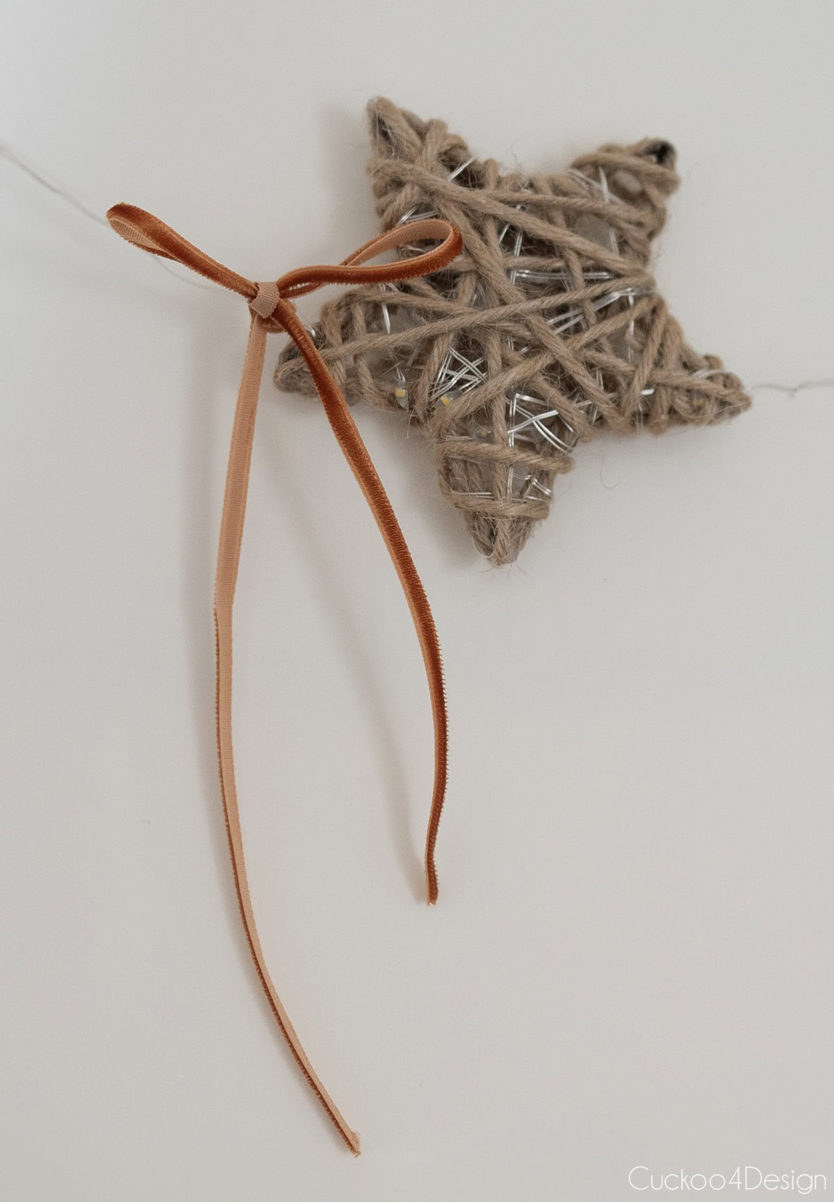 close-up of light-up yarn star with bow and lights off