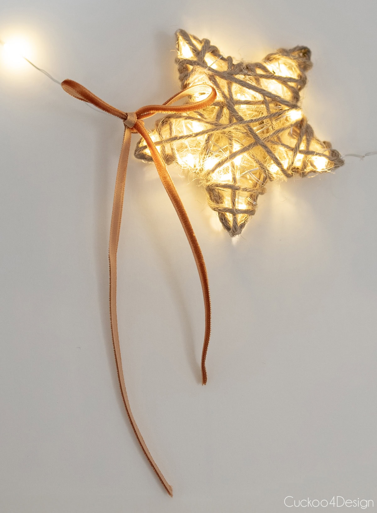 close-up of light-up yarn star with bow