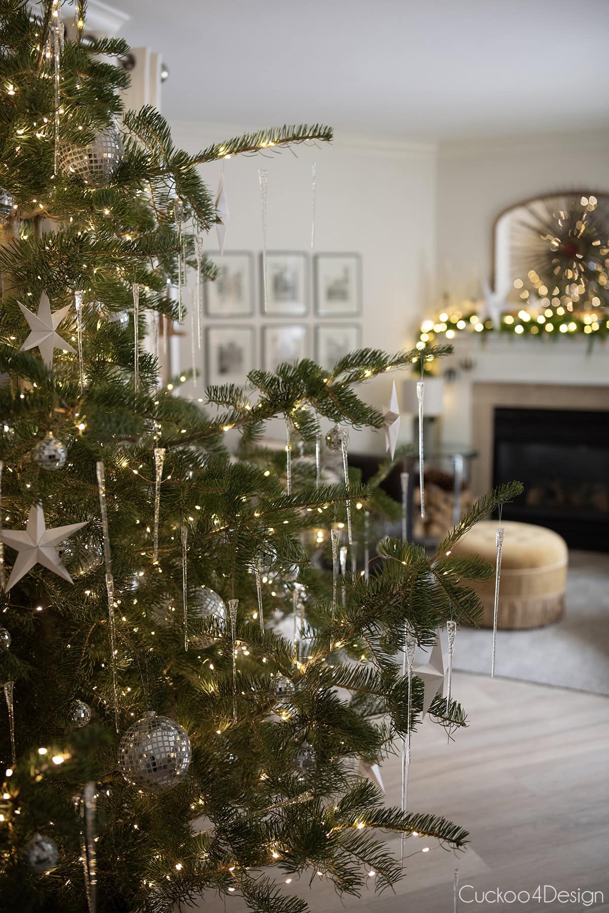 view of fireplace area behind the Christmas tree