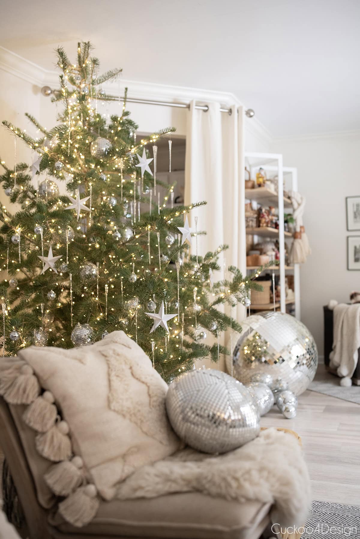 folded paper stars on Christmas tree with disco balls
