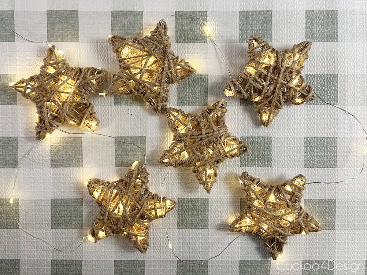 six yarn star ornaments with fairy ligths