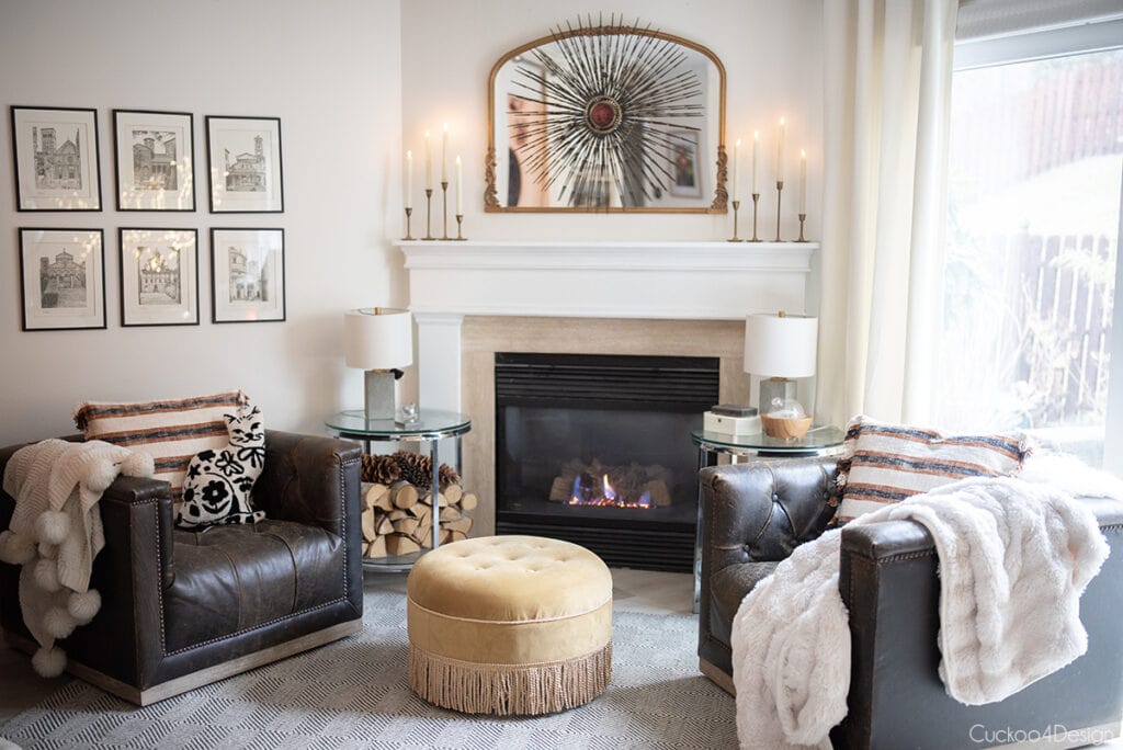 cozy fireplace area with faux fur blankets, leather swivel chairs and velvet ottoman