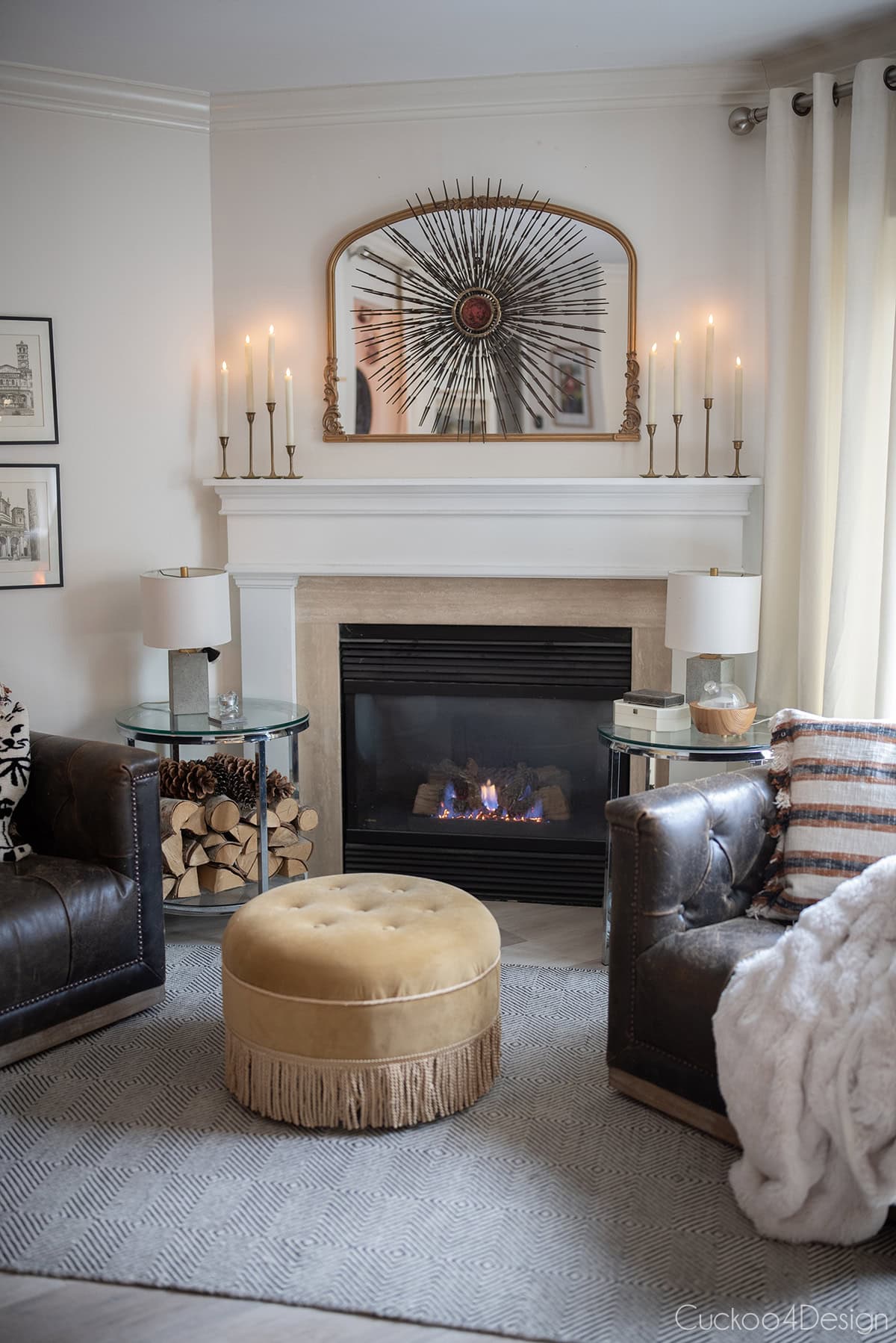 tall front view of cozy fireplace area with faux fur blankets, leather swivel chairs and velvet ottoman