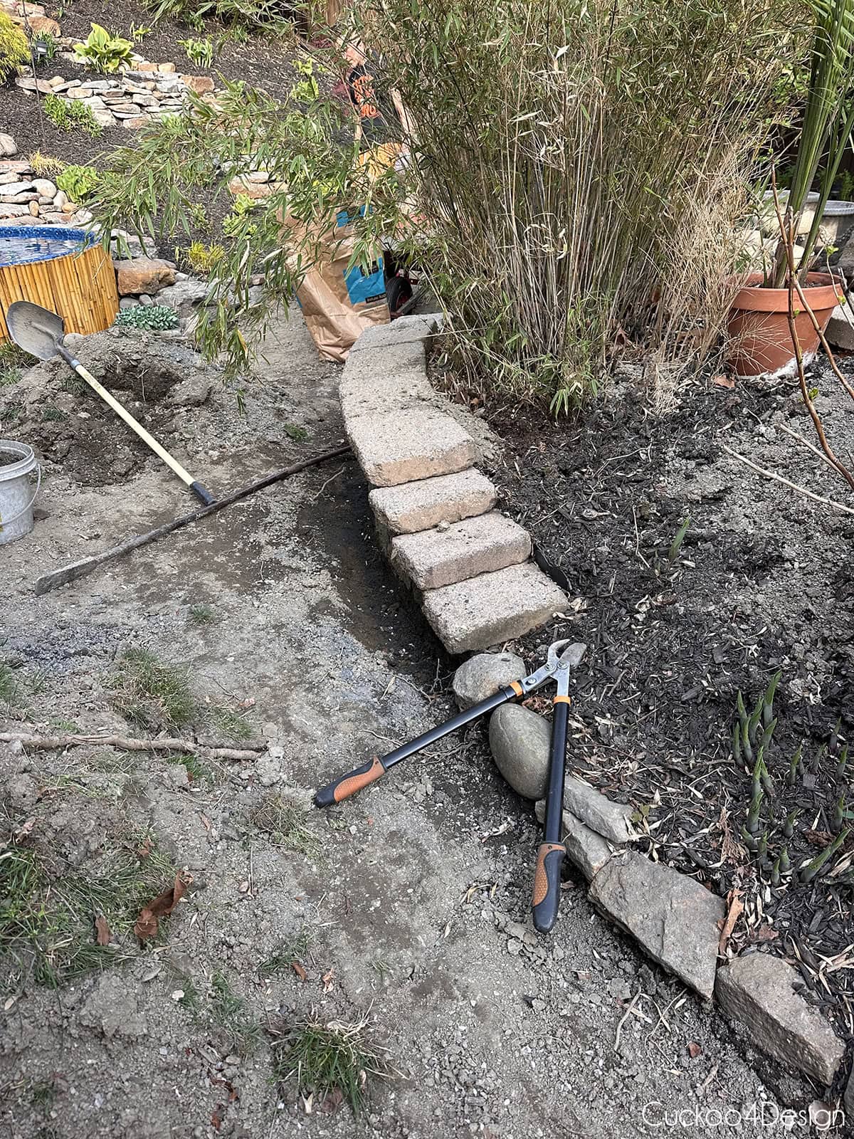 digging around leaning patio retaining wall
