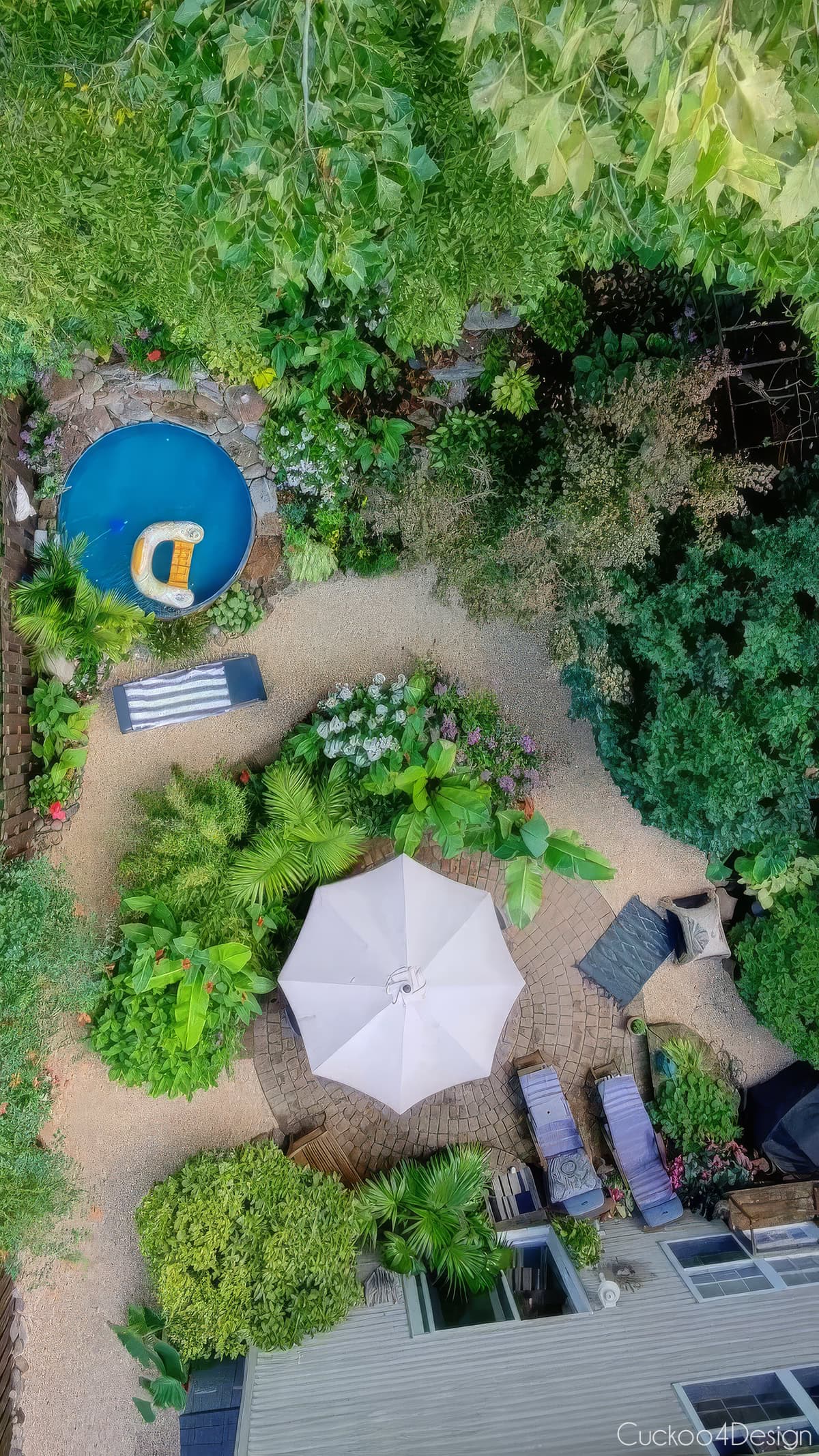 end of the summer 30 foot bird's-eye view of stock tank pool, pea gravel path, and landscaping