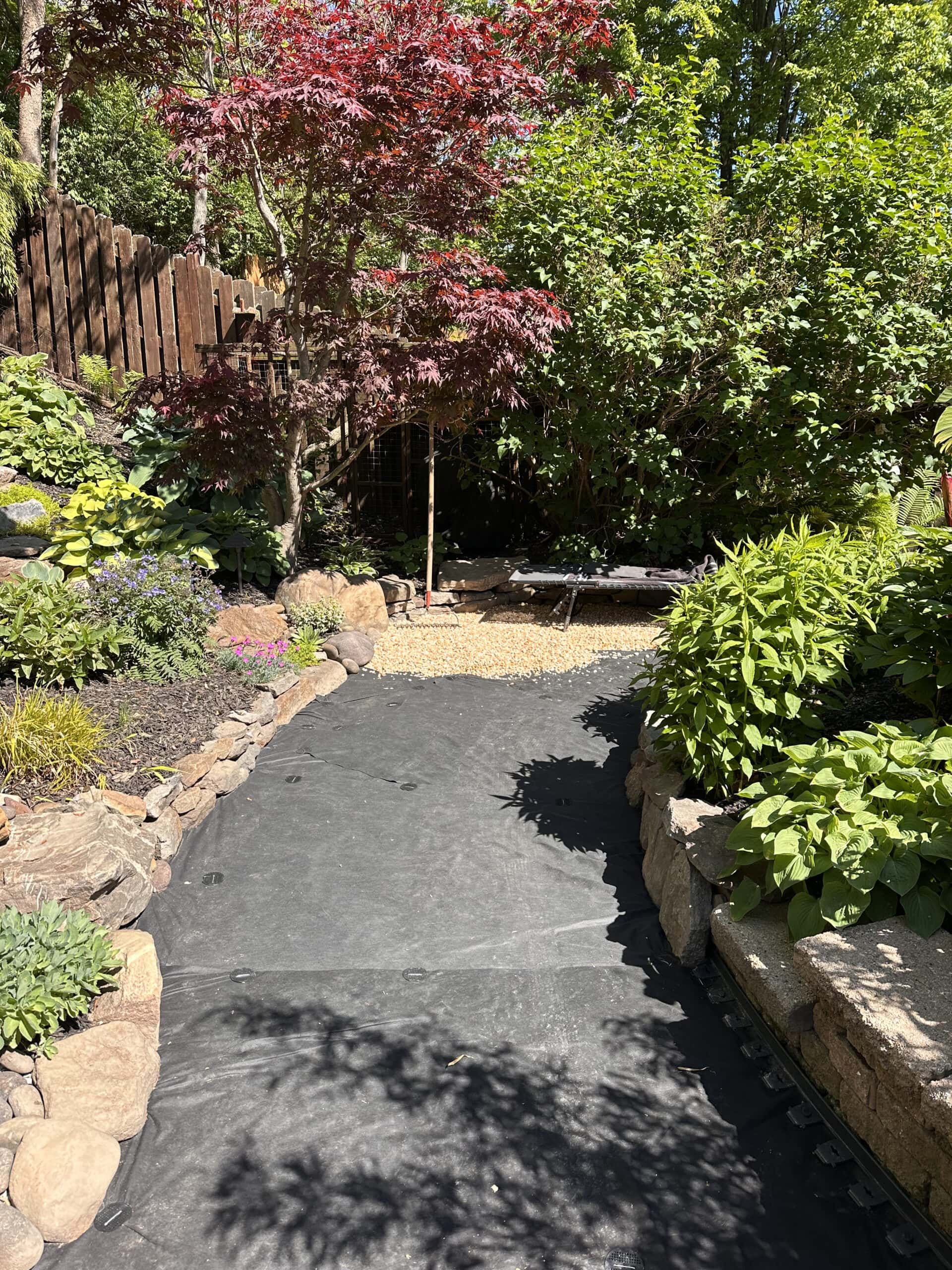 adding pea gravel onto landscaping fabric