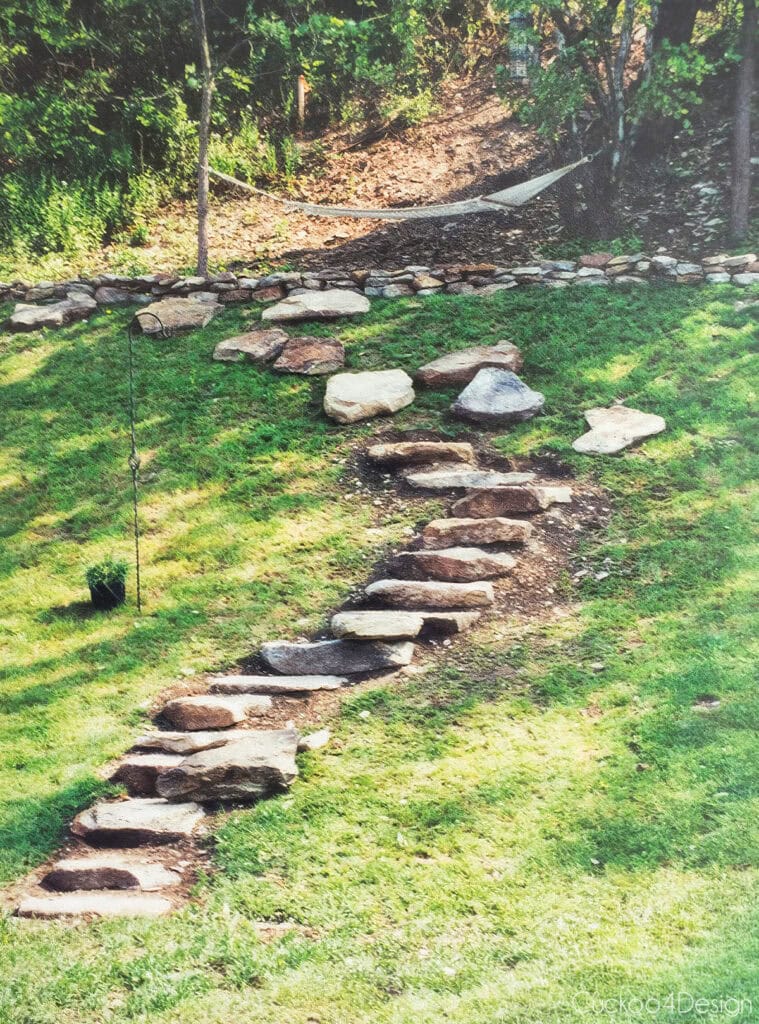 full view of backyard hill with the construction of rock stairs leading up