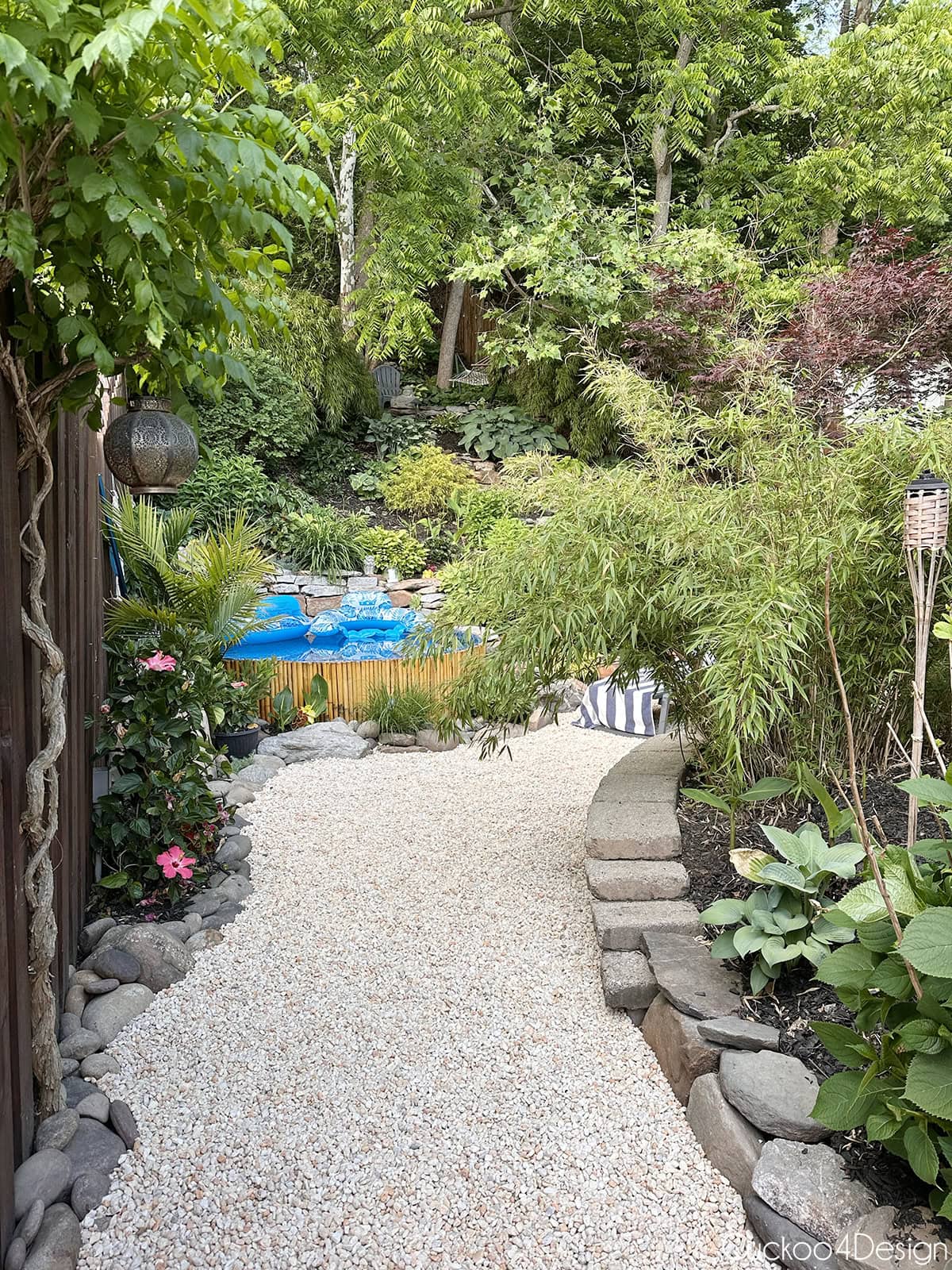 view of fence area towards the pool with plants grown more mature