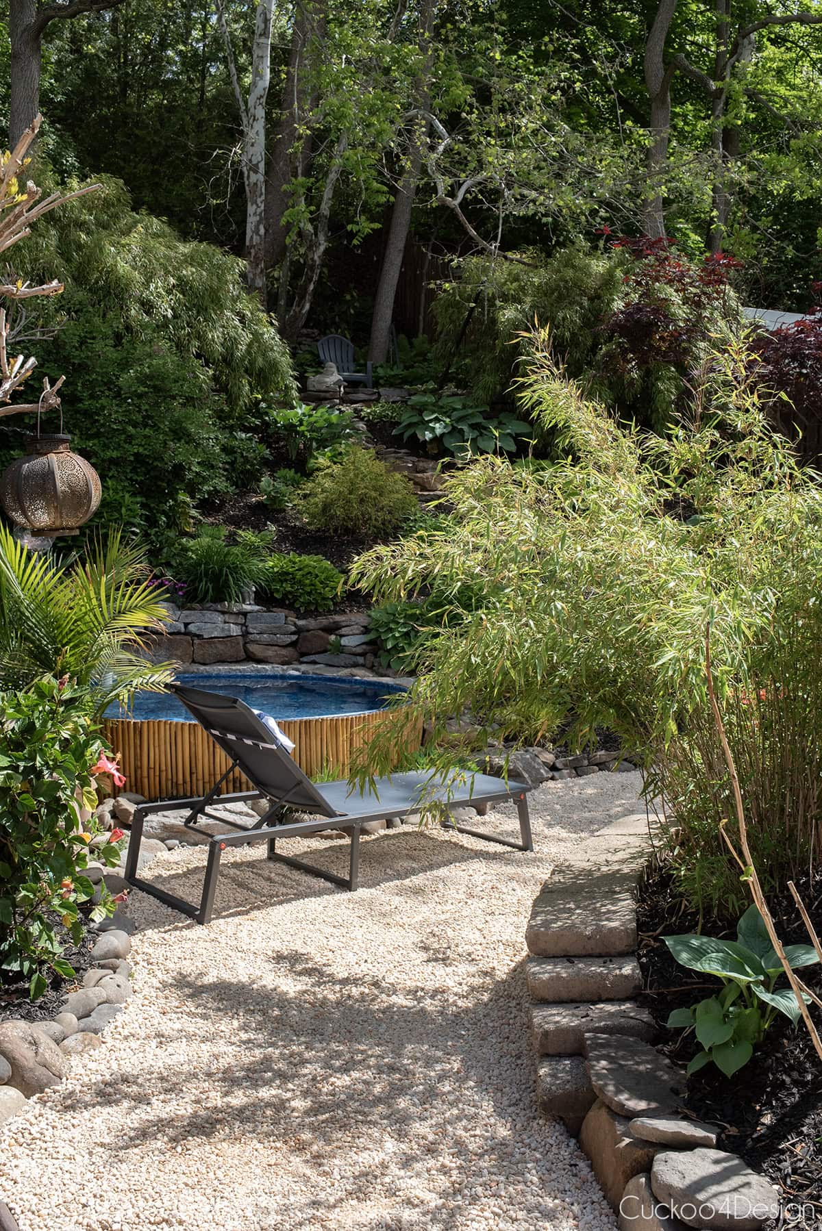 side yard view with stock tank pool and hill with landscaping
