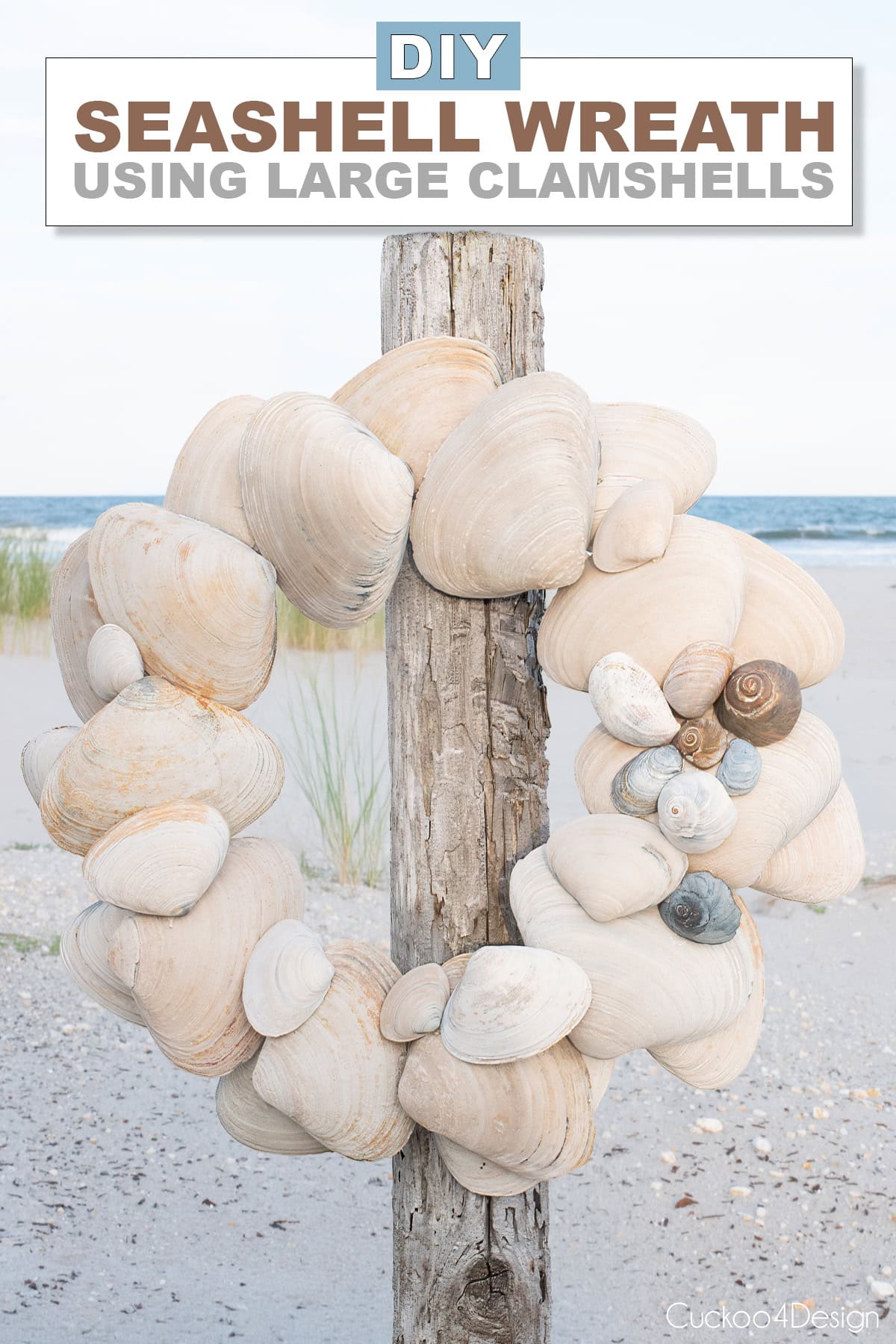 DIY seashell wreath made with large clam shells hanging on a driftwood post at the beach, with text overlay reading DIY Seashell Wreath Using Large Clamshells