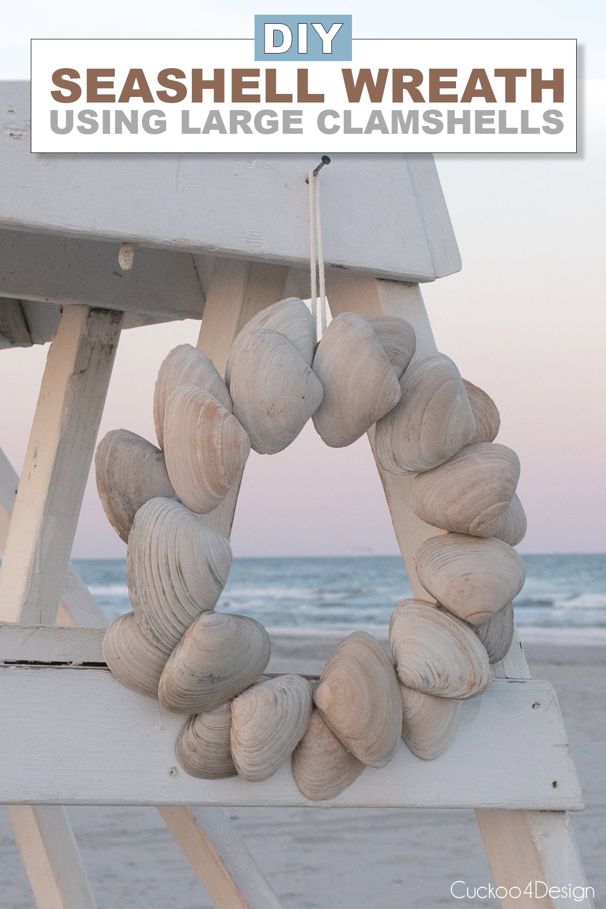 DIY seashell wreath made with large clam shells hanging on a white lifeguard chair at the beach