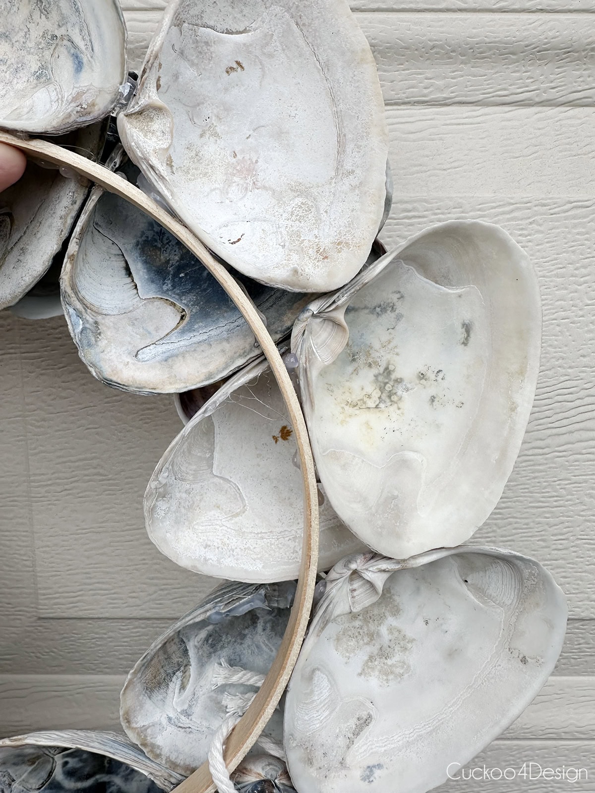 view of the back side of the DIY seashell wreath after removing the plastic bag