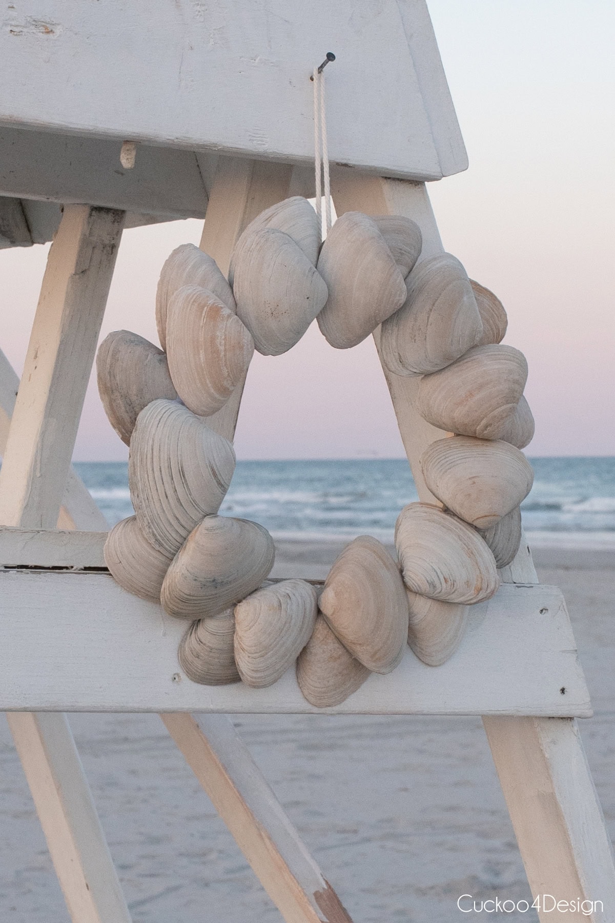 DIY seashell wreath hanging on lifeguard stand