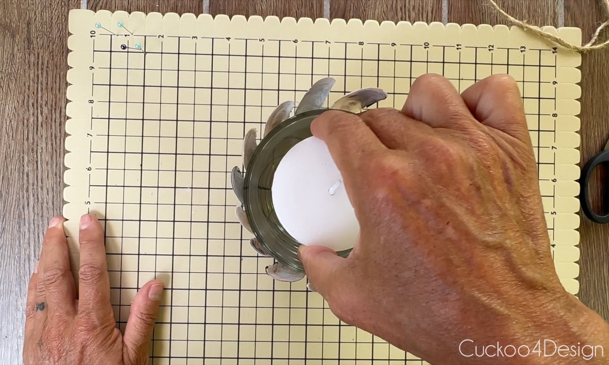 inserting a candle into glass vessel