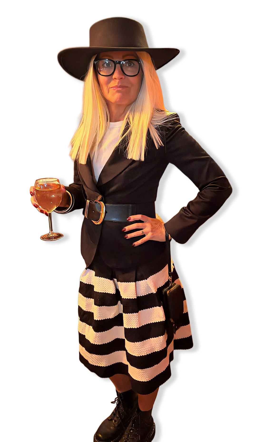 full length view of a Diane Keaton costume with a black hat, glasses, black blazer, black and white striped skirt, and black boots in front of white background
