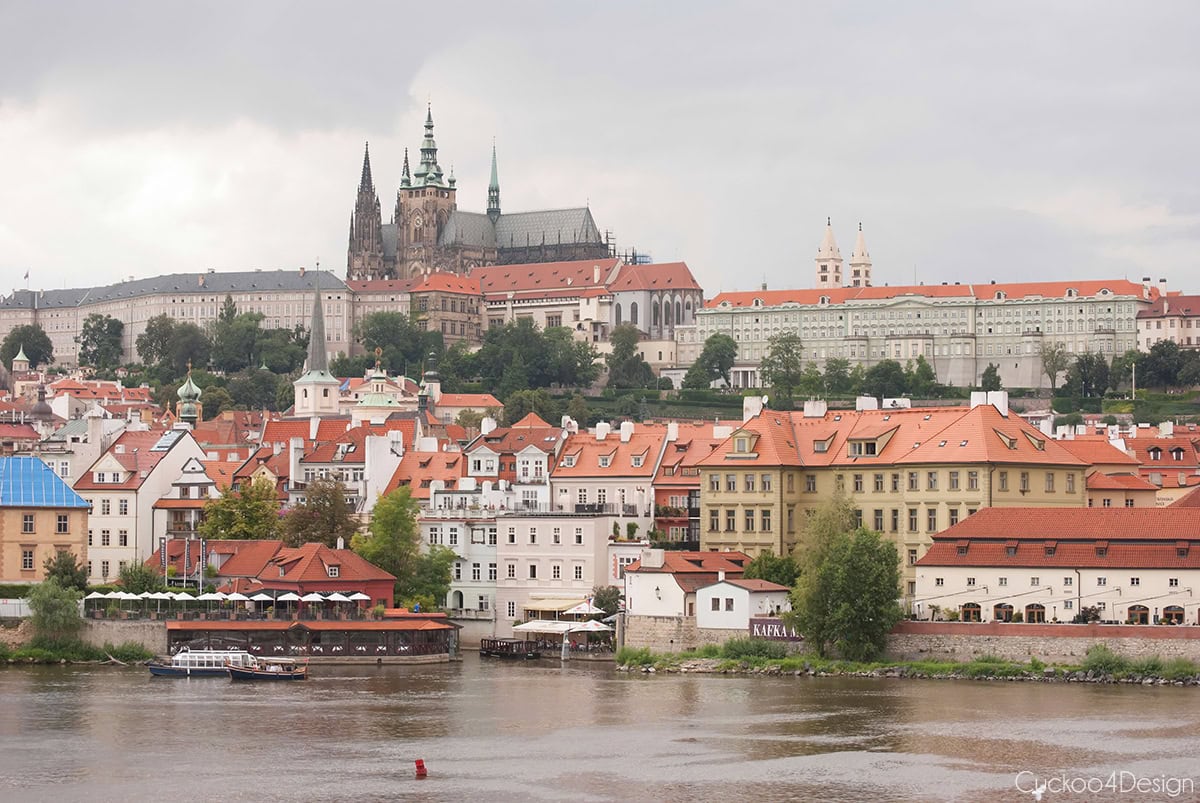 Prague Castle and St. Vitus Cathedral above the Vltava River and the red rooftops of the Lesser Town